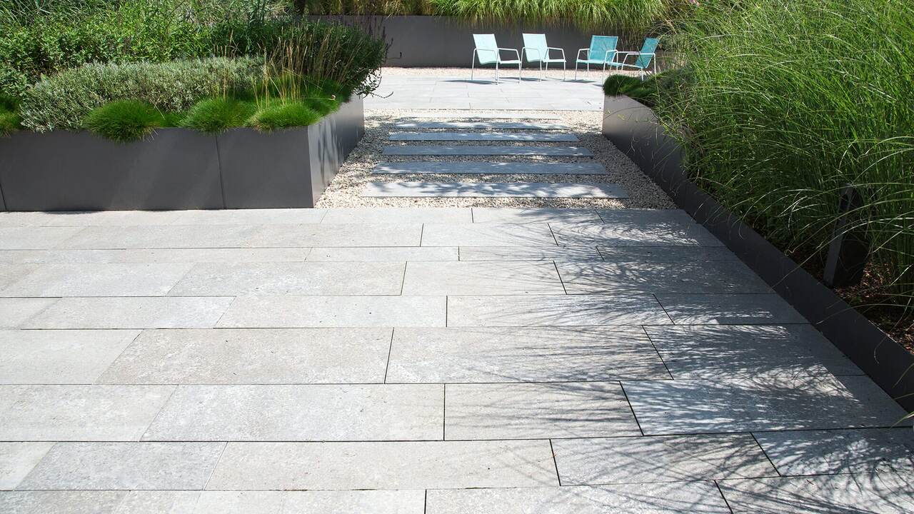 Aangelegde tuin met gazon, borders en terras door Tuinwerken Boutsen